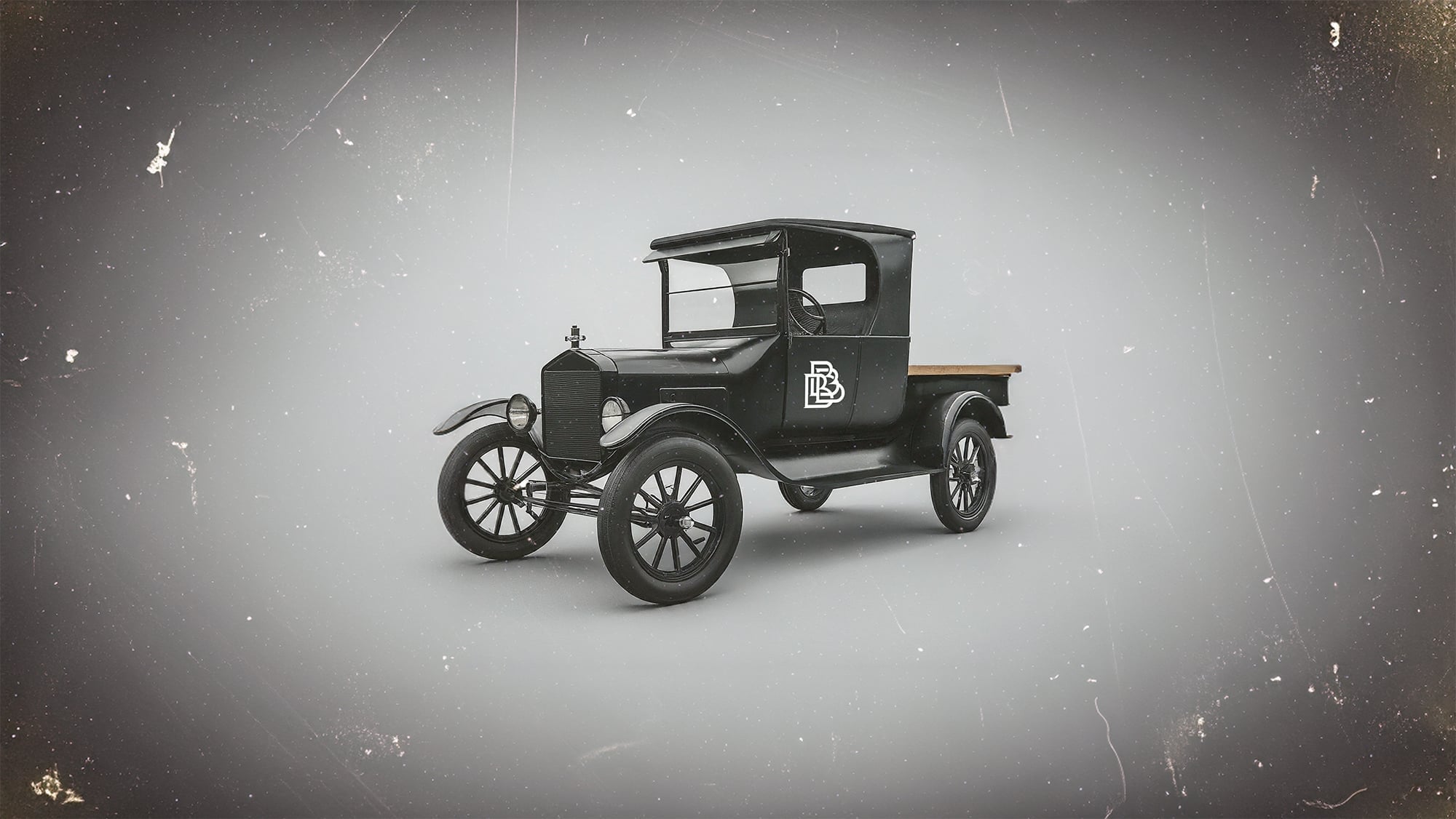 A vintage black and white illustration of a 1920s-era delivery van.